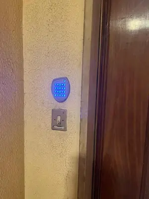 a door with a blue button on a wall at TopVaticanApartment in Rome