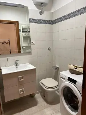 a bathroom with a washing machine and a washer at TopVaticanApartment in Rome