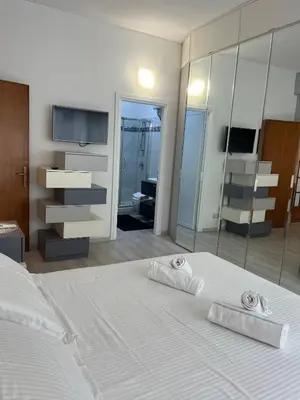a bedroom with a large white bed with towels on it at TopVaticanApartment in Rome
