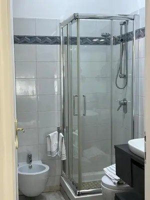 a bathroom with a shower and a toilet and a sink at TopVaticanApartment in Rome