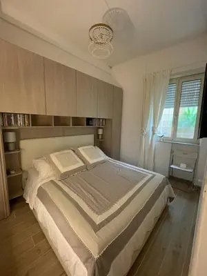 a bedroom with a large bed and a window at Bilocale Socrates in Rome