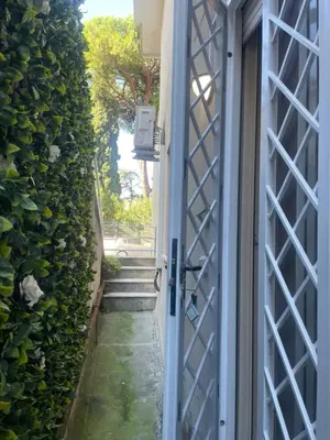 an open door to a stairway with a gate at Bilocale Socrates in Rome