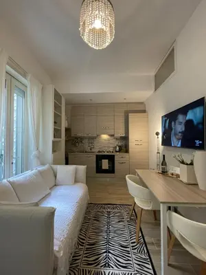 a living room with a white couch and a table at Bilocale Socrates in Rome