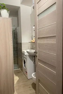a bathroom with a toilet and a sink and a washing machine at Bilocale Socrates in Rome