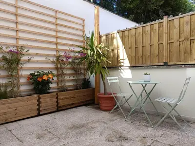 a patio with a fence and a table and chairs at A casa di Piero in Rome