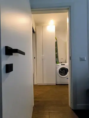 an open door to a laundry room with a washing machine at A casa di Piero in Rome