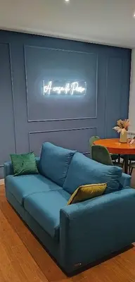 a blue couch in a living room with a table at A casa di Piero in Rome