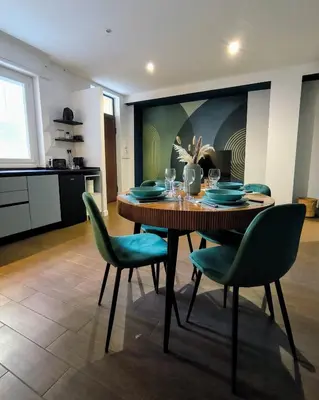 a dining room with a table and green chairs at A casa di Piero in Rome
