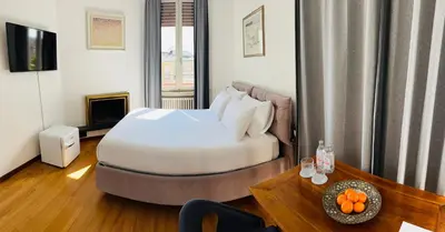 a hotel room with a bed and a table with oranges at Terrazza Urania - Penthouse terrace with 360 view of Rome in Rome