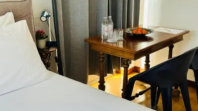 a bedroom with a table with a bowl of oranges on it at Terrazza Urania - Penthouse terrace with 360 view of Rome in Rome
