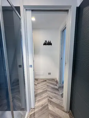 a hallway with a glass door leading into a room at F House Trastevere in Rome
