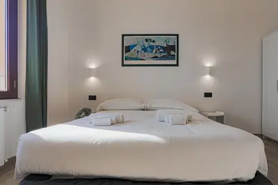 a bedroom with a large white bed with two pillows at Vatican Vista Apartment in Rome