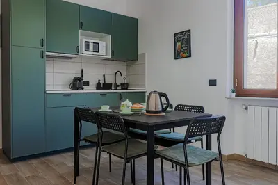 a kitchen with a table with chairs and a microwave at Vatican Vista Apartment in Rome
