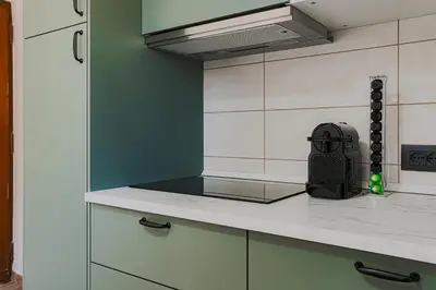 a kitchen with a counter top with a stove at Vatican Vista Apartment in Rome