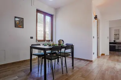 a dining room with a black table and chairs at Vatican Vista Apartment in Rome