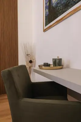a black chair sitting in front of a table at Re Di Rhome Guest House in Rome