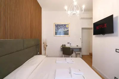 a small room with a bed and a desk at Re Di Rhome Guest House in Rome