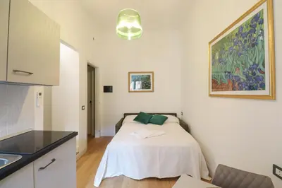 a white bedroom with a bed in a room at Re Di Rhome Guest House in Rome