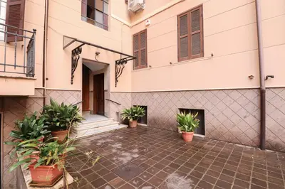 a courtyard of a building with potted plants at Re Di Rhome Guest House in Rome