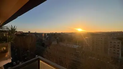 a balcony with a table and a view of a city at StepaHouse Roma zona San Paolo Elegante Bilocale a 2 minuti dalla Metro B in Rome