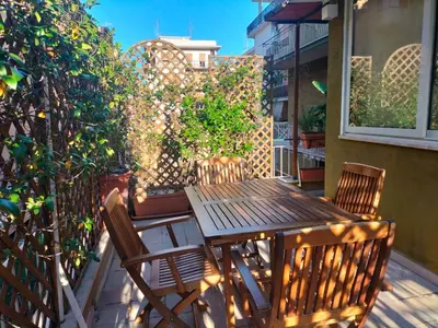 a wooden table and chairs sitting on a patio at Cento House Casa Vacanze Roma in Rome