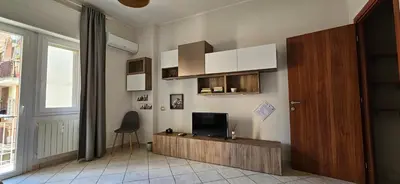 a living room with a flat screen tv on the wall at Cento House Casa Vacanze Roma in Rome