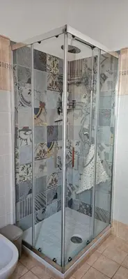 a shower with glass doors in a bathroom at Cento House Casa Vacanze Roma in Rome