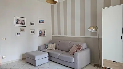 a living room with a couch and a lamp at Cento House Casa Vacanze Roma in Rome