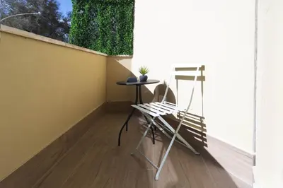 a chair and a table on a balcony at GENESI Suites in Rome