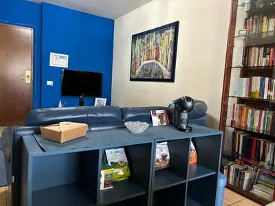 a room with a book shelf filled with books at GrElly's House - Holiday in Rome - 50 meters from the Metro in Rome