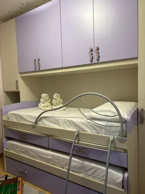 a room with a bed and a chess board in front of a door at GrElly's House - Holiday in Rome - 50 meters from the Metro in Rome