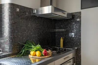 a kitchen with a bowl of fruit on a counter at iFlat Trevi's Paradise in Rome