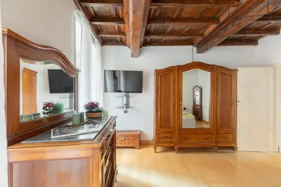 a room with a wooden dresser and a mirror at iFlat Trevi's Paradise in Rome