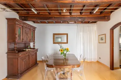 a dining room with a wooden table and chairs at iFlat Trevi's Paradise in Rome