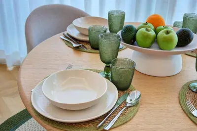 a table with plates and bowls of fruit on it at Green Tevere Rooftop in Rome