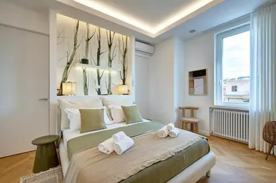 a bedroom with a large bed with towels on it at Green Tevere Rooftop in Rome