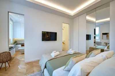 a room with three beds and a tv on a wall at Green Tevere Rooftop in Rome