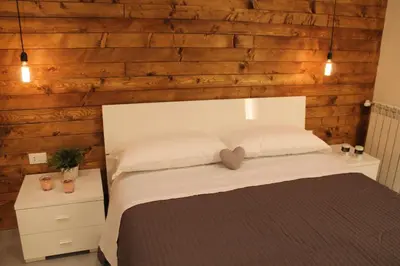 a bedroom with a bed with a wooden wall at B&B Girovagando in Rome