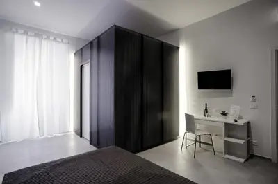 a bedroom with a bed and a desk and a tv at B&B Girovagando in Rome