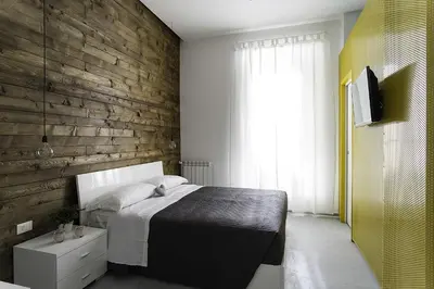 a bedroom with a bed and a wooden wall at B&B Girovagando in Rome