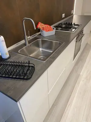 a kitchen counter with a sink and a stove at CasaFaleria in Rome