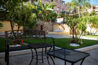 two chairs and a table in a courtyard at Residenza Leone XIII in Rome