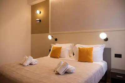 a bedroom with a large bed with yellow and white pillows at Residenza Leone XIII in Rome