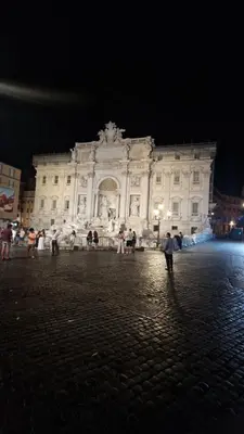 a large white building with people standing in front of it at Luxury Apartment delle Fratte in Rome
