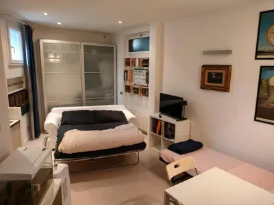 a bedroom with a bed and a tv in it at Euclide apartment in Rome
