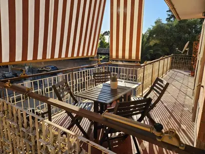 a wooden deck with a table and chairs on a balcony at Like at Home Gianicolense in Rome