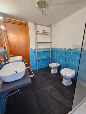 a bathroom with two toilets and a sink at Like at Home Gianicolense in Rome