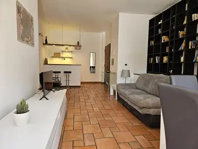 a living room with a couch and a kitchen at Like at Home Gianicolense in Rome