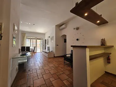a living room with a kitchen and a dining room at Like at Home Gianicolense in Rome