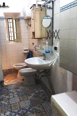 a bathroom with a sink and a toilet at Green House Roma in Rome